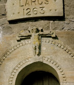 Detail of carving of crucifixion at head of doorway