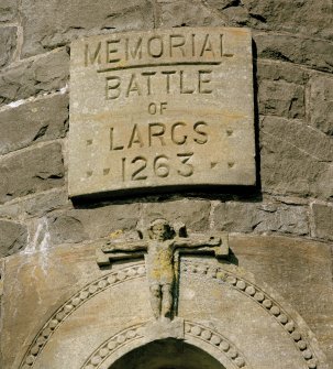 Detail of carved memorial plaque above doorway
