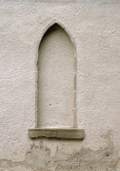 Detail of blocked arched window at ground floor level