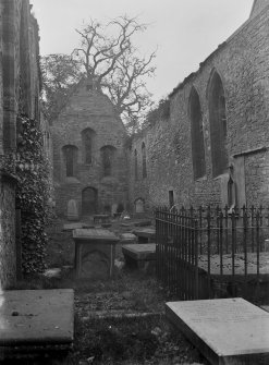 Interior of nave towards entrance, showing gravestones
