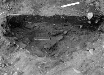 Excavation photograph: Film 96/BW/2: Feature L23: E half under excavation showing pottery at Littleour. Illustration 48.