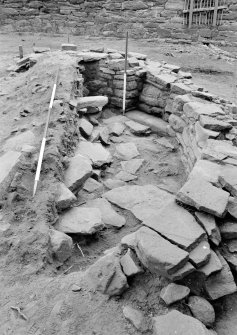 Excavation photograph: Film 10, Frame 12 - Structure F308 with floor exposed on east side. View from the south. From the 1996 season excavation at Melgund Castle.