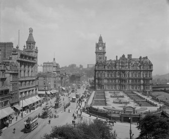 View from Scott Monument looking east towards Calton Hill showing the North British Hotel, Waverley Gardens and a busy Princes Street with shop awnings, pedestrians, trams, buses and horse and carts.