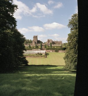 Distant view of keep, mansion and garden from South.
