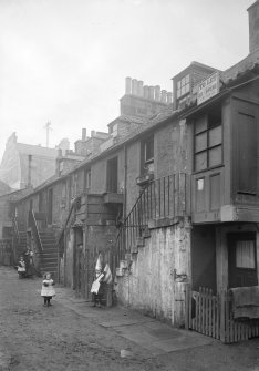 View of children playing outside Stockbridge houses.