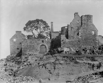 View of castle ruins and men digging