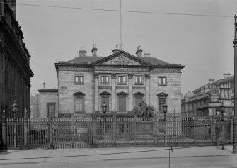 View of front facade and forecourt from West.