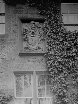 Detail of heraldic stone in wall of farmhouse.