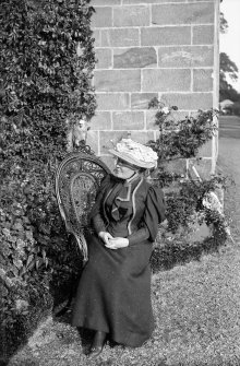 Photograph of woman sitting outside Culross Abbey House, Fife.
Scanned image from original glass plate negative. Original envelope annotated by Erskine Beveridge 'Sarah & Jacko Culross Abbey'. Possibly Erskine Beveridge's older step-sister.