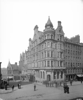 General view of bank at junction of High Street and Cockburn Street with policemen standing in middle of High Street