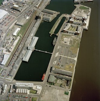 Scanned image of oblique aerial view centred on the docks and wharf, taken from the SW.