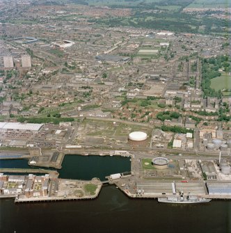 Scanned image showing general oblique aerial view of Dundee, the dock, gasworks and football stadiums, taken from the SE.