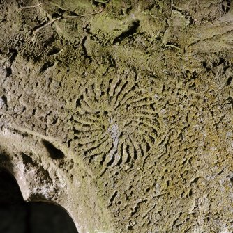 Detail of incised carving over window at E end of S wall.