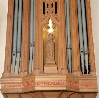 Interior.
Detail of carved figure in niche between organ pipes.