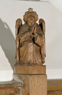 Interior.
Detail of carved angel on pew end.