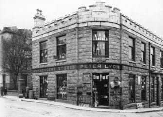 General view showing corner premises of Peter Lyon, Ironmongery Stores constructed in 1900.
