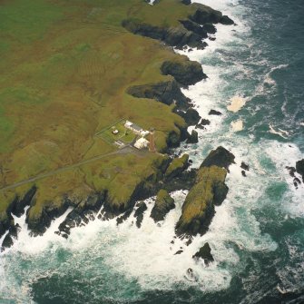 Oblique aerial view centred on the Butt of Lewis lighthouse with the remains of the enclosures adjacent, taken from the ENE.