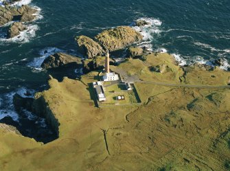 Oblique aerial view centred on the Butt of Lewis lighthouse with the enclosure adjacent, taken from the SW.
