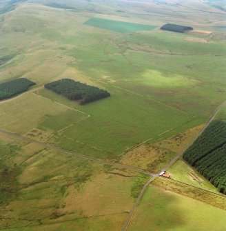 Pennymuir, oblique aerial view, taken from the NE, centred on Roman Temporary Camps, a linear earthwork and an area of rig. The course of 'Dere Street' is visible in the bottom half of the photograph.