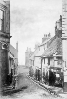 View looking down street, Paisley
Titled: 'St Mirin's Wynd'
Inscribed on verso; 'Up till 1880 or so Causeyside could not be reached directly by St Mirins St (Wynd), you had to go down to Cart Walk and then up Water Brae.  Earlier still the St Mirin Burn had to be crossed where street now is.'