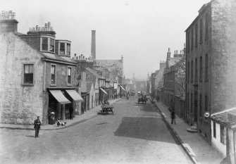 View down street in Paisley with horses and carts.
Titled: 'Old Sneddon St.'
Inscribed on verso: 'Valuable.'