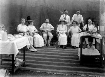 Seated group with tennis racquets.  Unknown location, probably Kolkata.