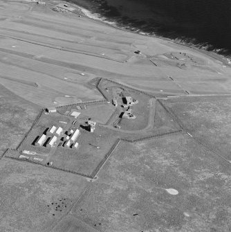 Oblique aerial view of Orkney, taken from the NW of Ness WW II coast battery and accommodation camp with Ness WWI coast battery and Links WWII coast battery in the background.