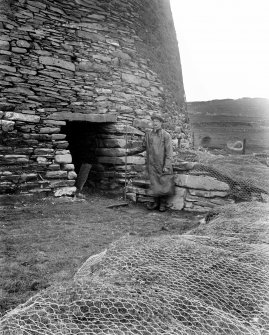View of entrance to Mousa Broch, with standing figure.