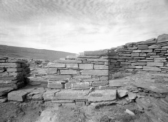 View of nave, showing N doorway, stone bench and N altar cell.