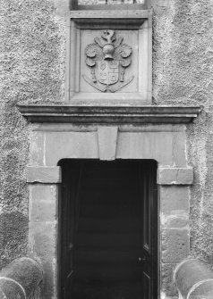 Detail of doorway with coat of arms above.