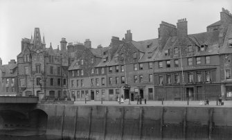 View of The Shore, Leith, showing William Rutherford pub, Thiems’ Foreign Ship Hotel and Coffee & Billiard Rooms, J G Campbell Perfumer and Hairdresser and R & D Slimon Ironmongers and Coppersmith.
