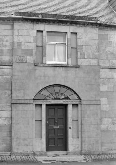 Scanned image of detail of front entrance and first floor window.