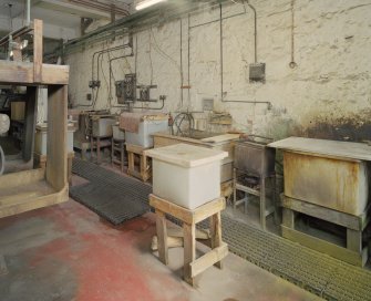 Interior. Lower ground floor. Workshop. View of plating tanks from SW