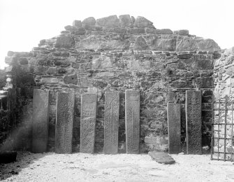 Mull, Inchkenneth Chapel, interior.
View of 8 carved stones, ranged against West wall of chapel.