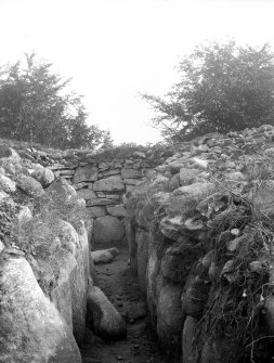 View of passage and interior of cairn.