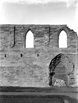 Historic photographic detail of doorway between cloister and S aisle.