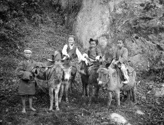 Group of children with donkeys.  Unknown location, possibly in Darjeeling or north Bengal.