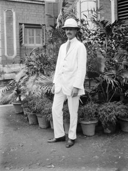 Unknown man standing outside house.
Unknown location.