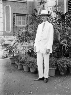 Unknown man standing outside house.
Unknown location.