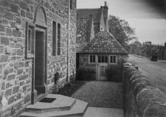 Photographic view, detail of doorway and outbuilding.
