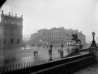 General view of corner of North Bridge and Princes Street, with horse-drawn trolley bus coming down North Bridge.