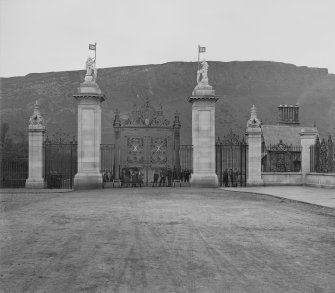 General view of South Gateway to Holyrood Palace from North, with group of people on outside of gates