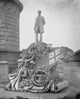 View of the American Civil War Memorial in Old Burial Ground on Waterloo Place, Edinburgh, decorated with flags and floral wreaths.
Insc. "Decoration Day. 1895. 248. AI."