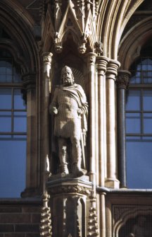 View of statue of Malcolm III, King of Scots, in left upper niche of main entrance, N facade.