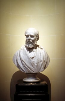View of marble bust of Daniel Rutherford Haldane M. D. by Charles McBride, 1888, at the top of the stairs outside the library, E side.