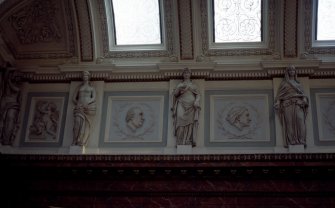 View of the frieze in the Hall, showing portrait profiles of James Gregory and John Hunter, with representations of Hygeia, and a panel carved with a cherub.