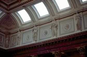 View of the frieze in the Hall, showing portrait profiles of William Harvey, Alexander Monro primus and William Cullen, with representations of Hygeia, and two panels carved with a cherub.