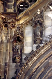 View of statues of Dugald Dalgetty and the Abbess (left to right), above ground floor arch, E side.