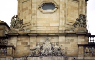 View of S side of building, showing two groups of putti, one at each side of the base of the octagonal drum, and the Bank of Scotland coat of arms.