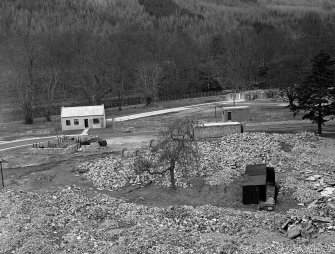 Taymouth Castle, Military Camp.
View of training area - looking North from Rescue Tower showing rubble in foreground, gas compound with 'Chlorine' Cottage on left, larch trees of Drummond Hill in background.